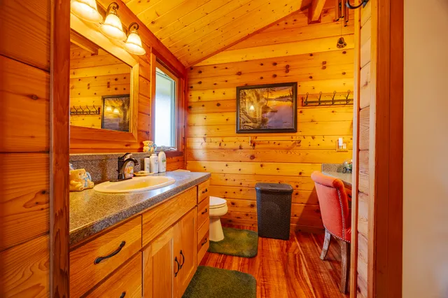 a view of a chairs and table in the back yard of the house