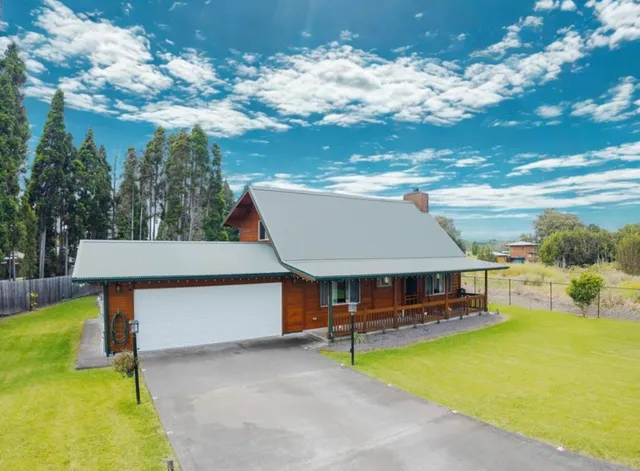 a view of a house with pool and chairs