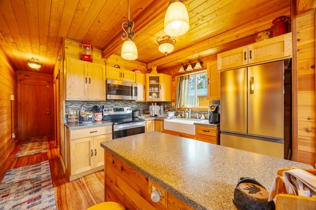 a kitchen with stainless steel appliances granite countertop a sink and cabinets