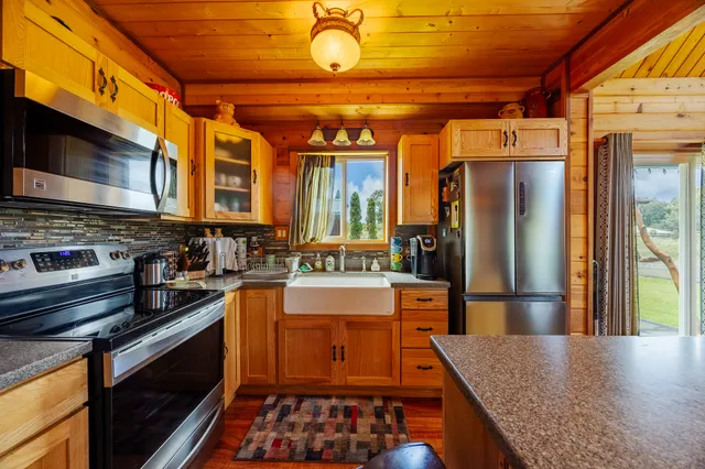 a kitchen with stainless steel appliances granite countertop a stove and a refrigerator