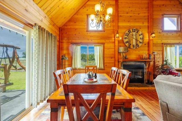 a view of a dining room with furniture a chandelier and wooden floor