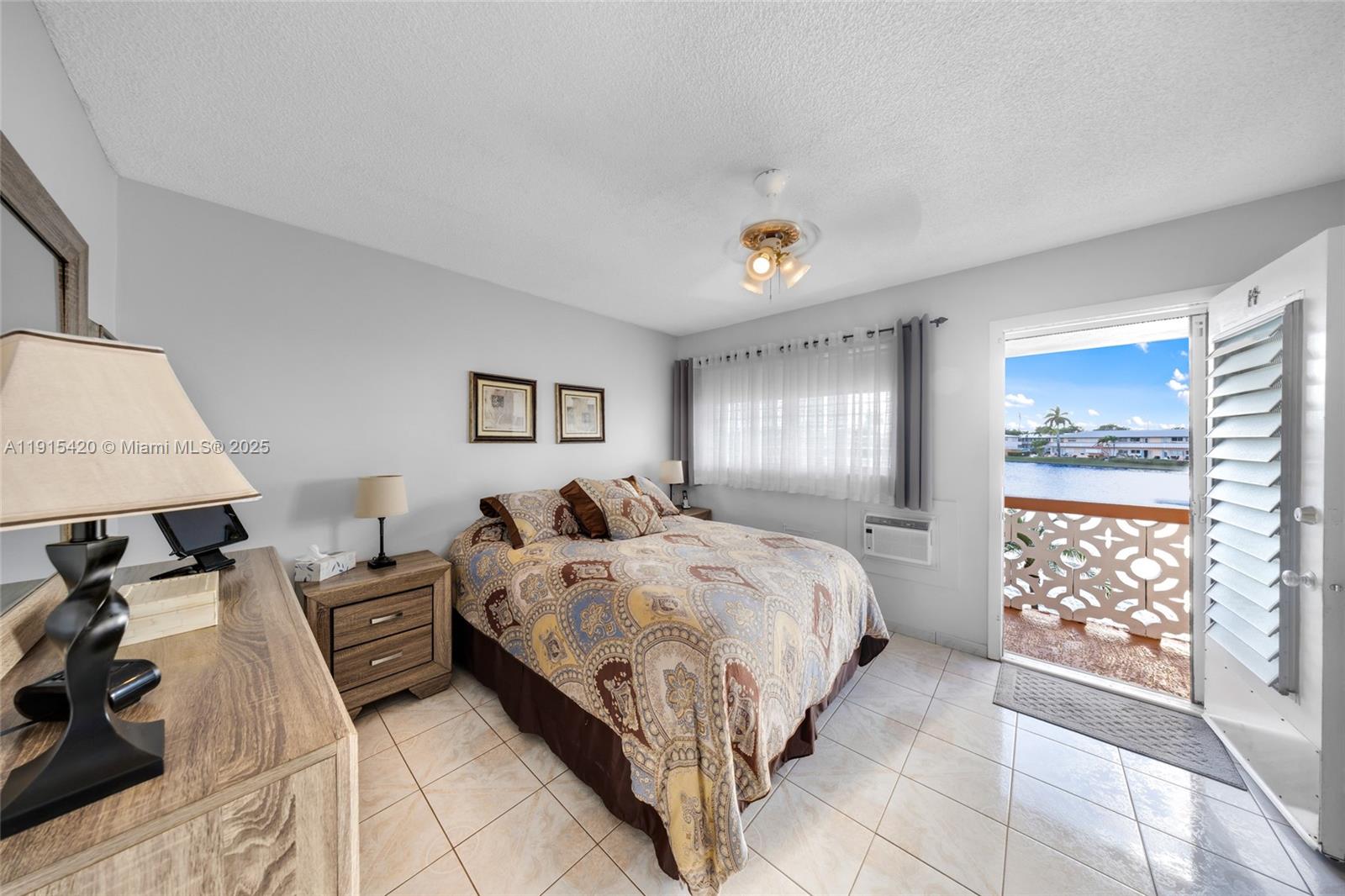 900 Southwest 10th Terrace, Unit 14S Hallandale Beach, FL 33009 - Photo 12 of 31 a bed room with a bed and a window