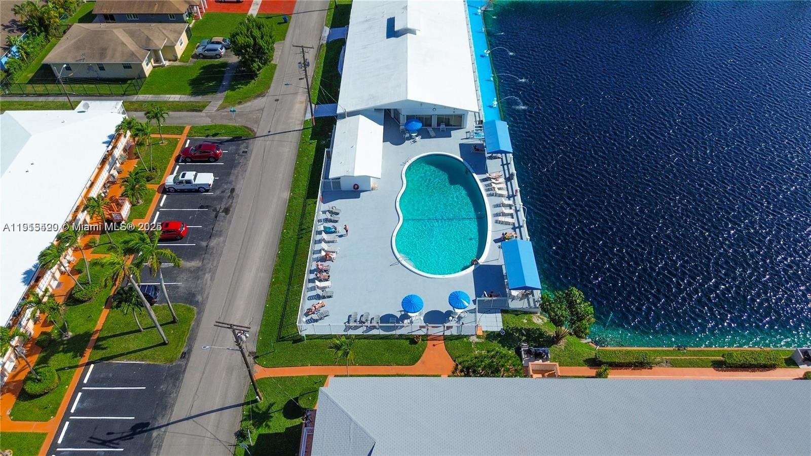 900 Southwest 10th Terrace, Unit 14S Hallandale Beach, FL 33009 - Photo 22 of 31 an aerial view of a house with swimming pool and outdoor space
