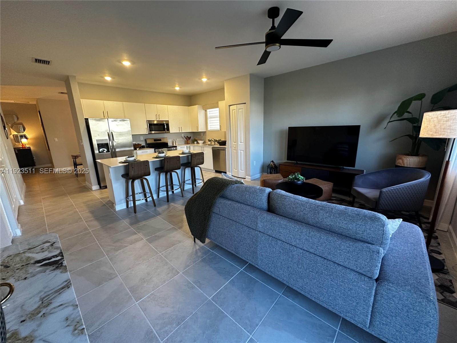 a living room with furniture and a flat screen tv