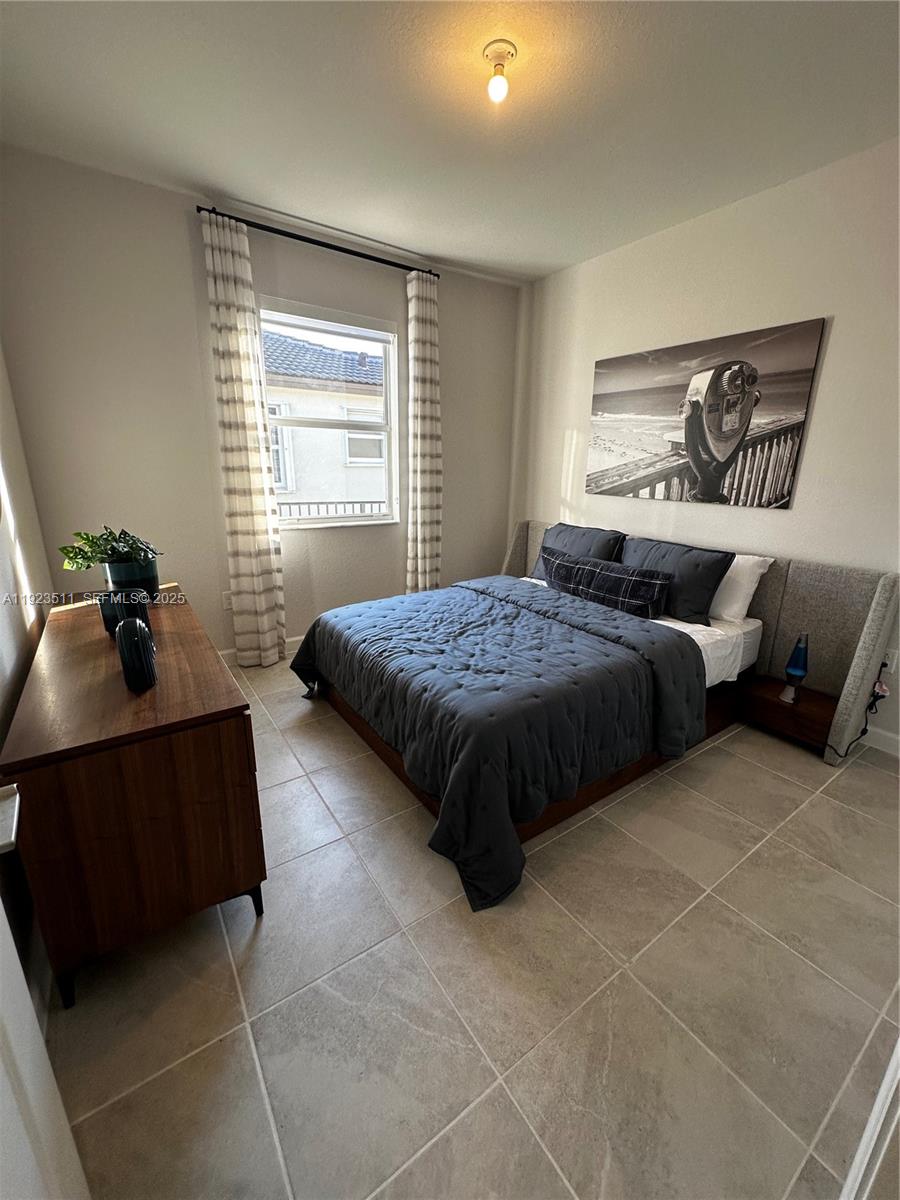 2288 Southeast 30th Street, Unit 1 Homestead, FL 33035 - Photo 11 of 23 a bedroom with a bed and window