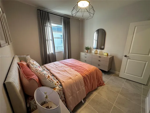 a bathroom with a double vanity sink mirror and shower