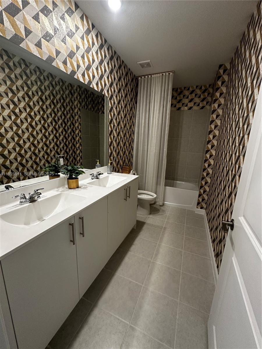 2288 Southeast 30th Street, Unit 1 Homestead, FL 33035 - Photo 16 of 23 a bathroom with a double vanity sink mirror and shower