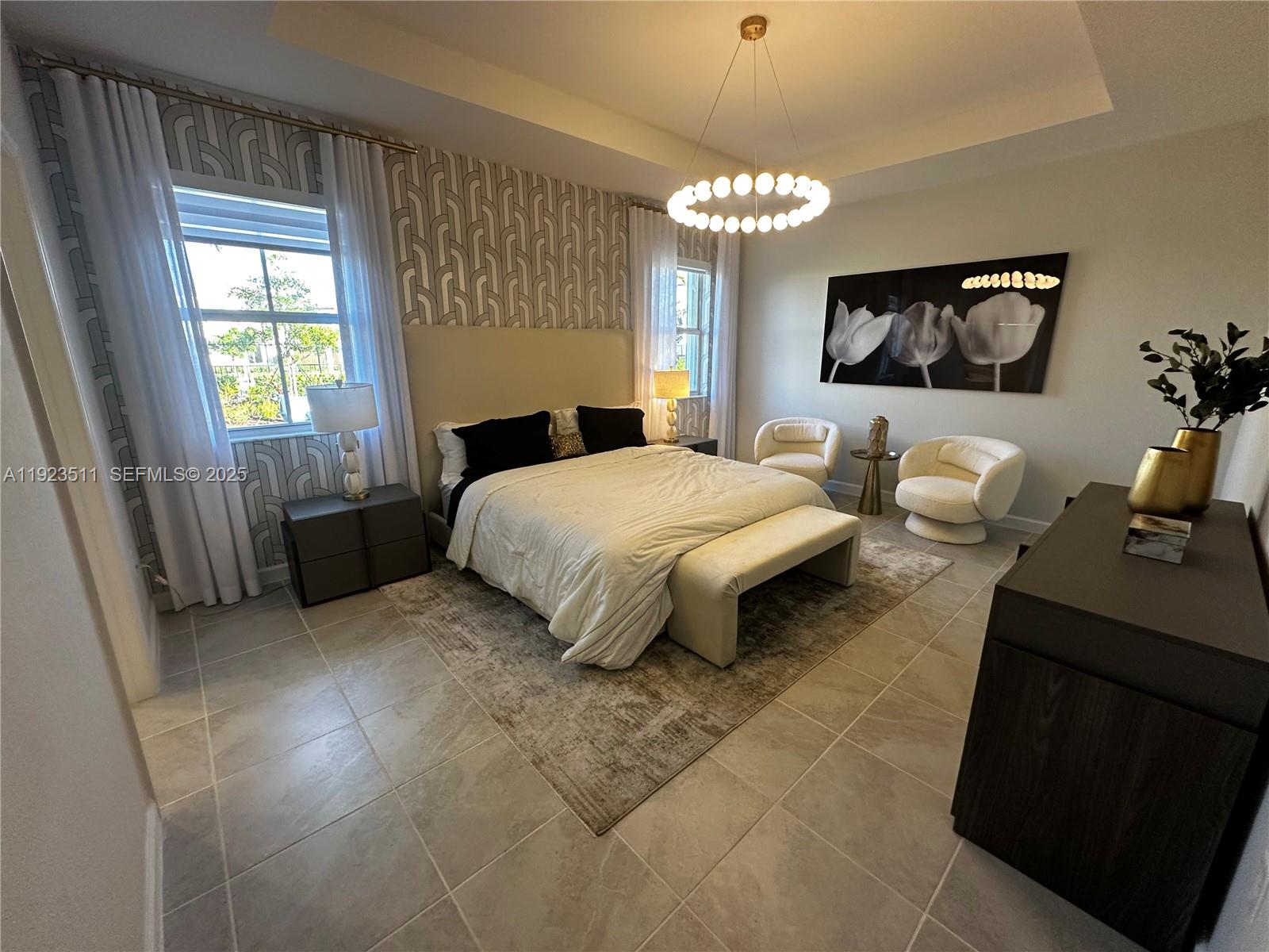 2288 Southeast 30th Street, Unit 1 Homestead, FL 33035 - Photo 18 of 23 a bedroom with a bed and a chandelier