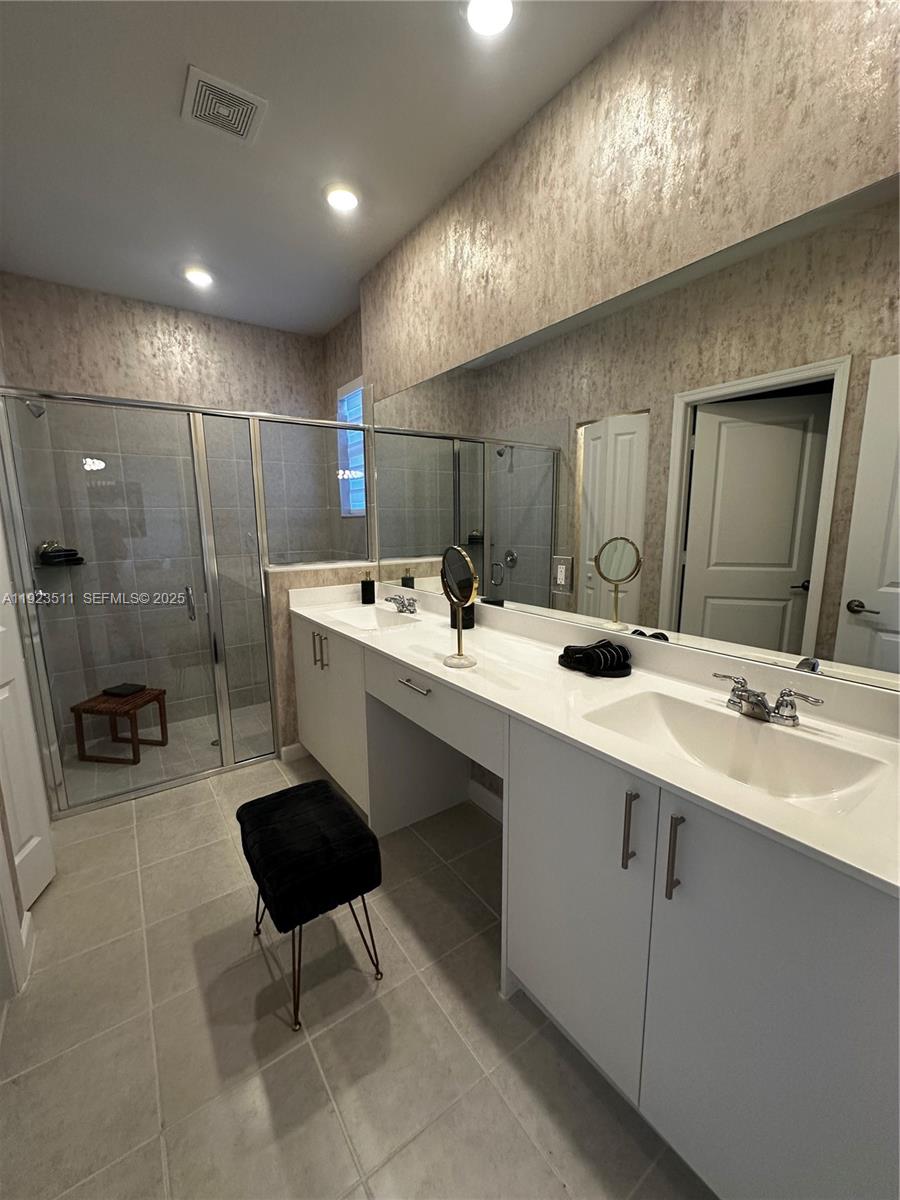 2288 Southeast 30th Street, Unit 1 Homestead, FL 33035 - Photo 20 of 23 a bathroom with a sink a toilet and a mirror