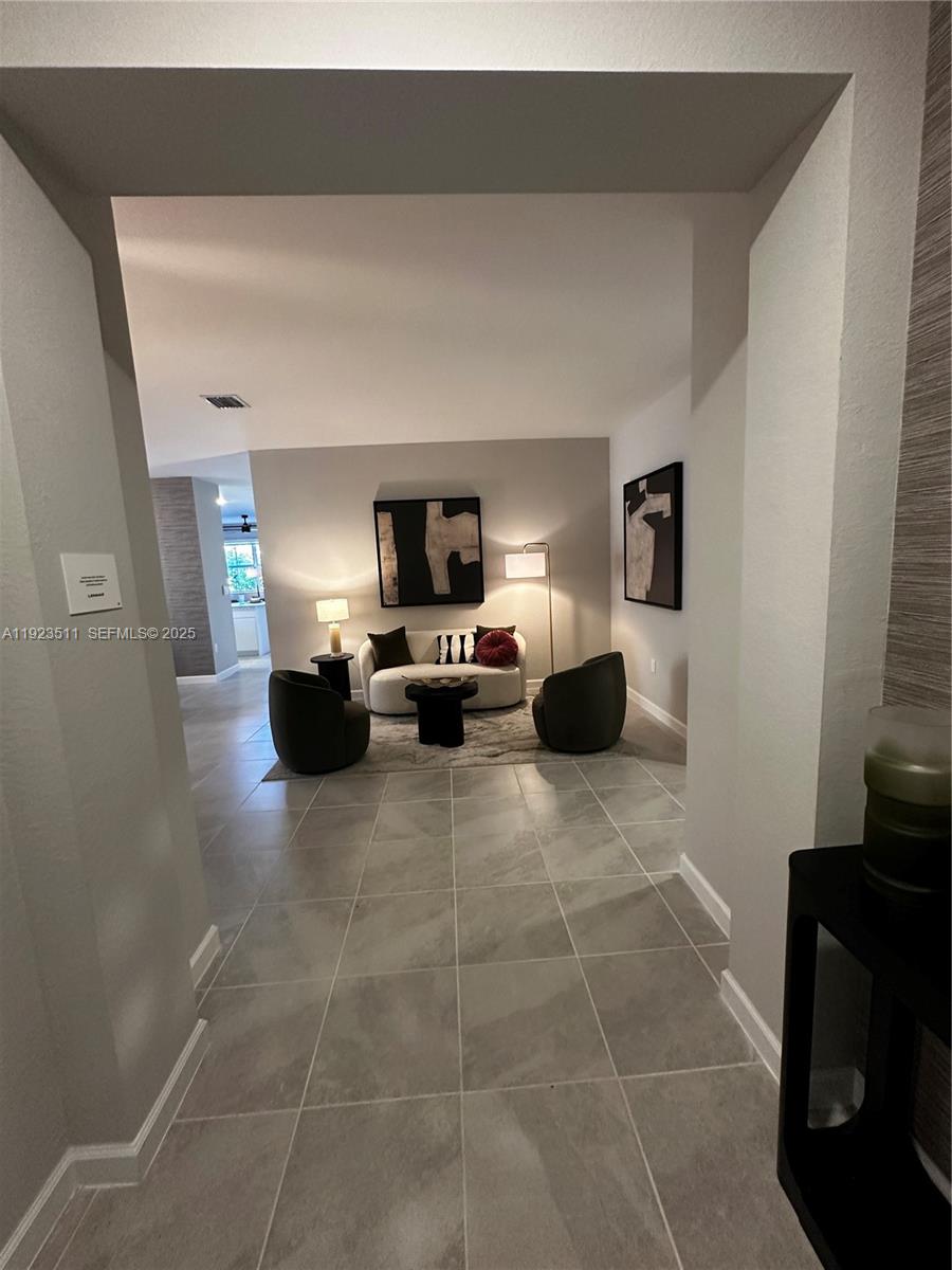 2288 Southeast 30th Street, Unit 1 Homestead, FL 33035 - Photo 3 of 23 a living room with furniture a flat screen tv and a window