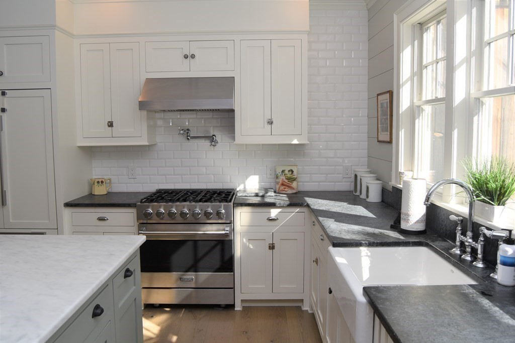 205 North Street Belchertown, MA 01007 - Photo 12 of 42 a kitchen with white cabinets and white appliances