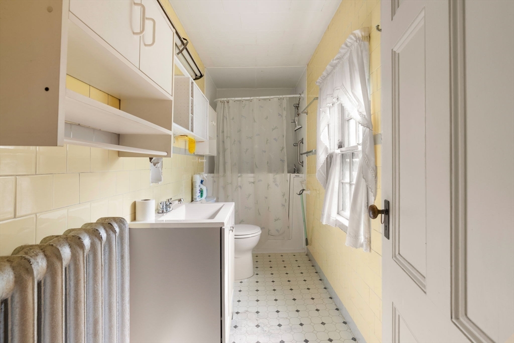 16 Ditson Place Methuen, MA 01844 - Photo 11 of 39 a bathroom with sink a toilet and shower