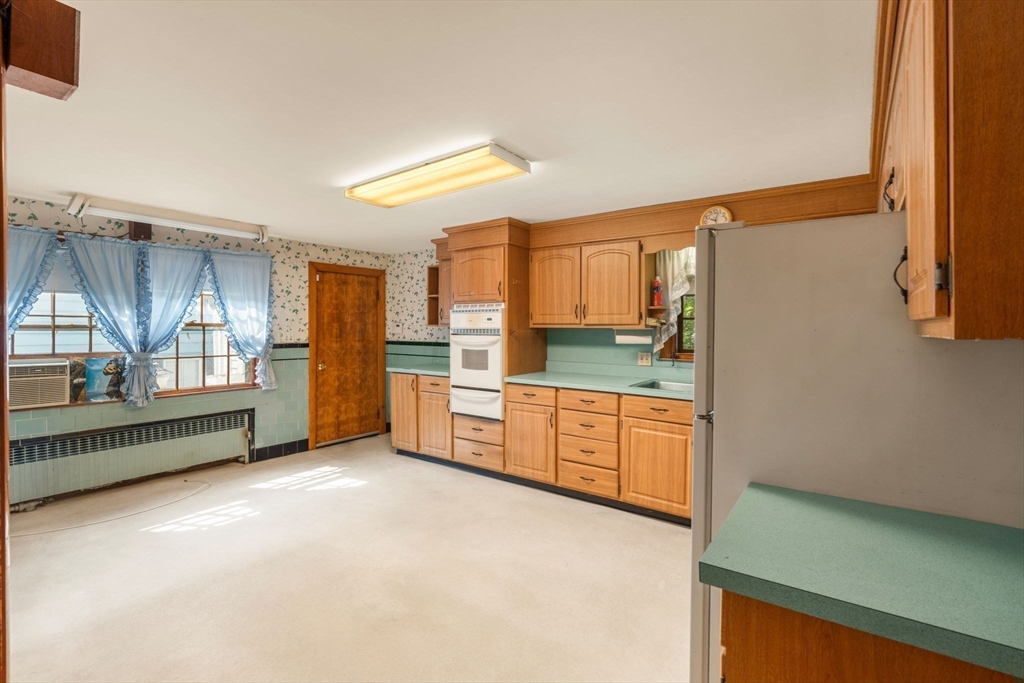 16 Ditson Place Methuen, MA 01844 - Photo 6 of 39 a large kitchen with a sink and dishwasher a stove top oven with wooden floor