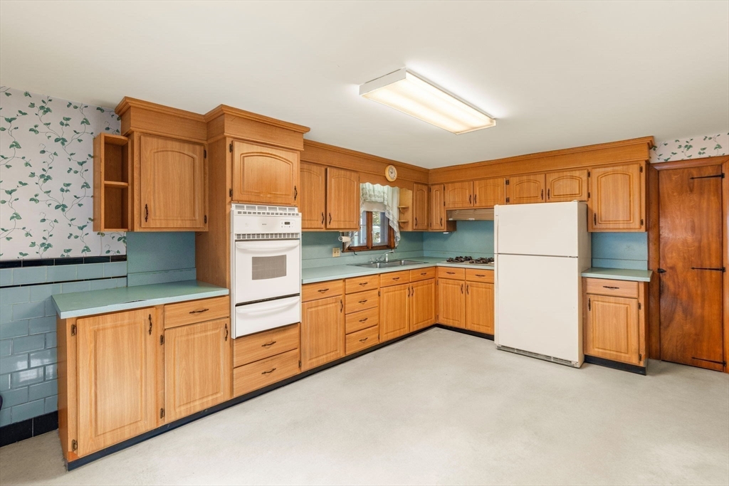 16 Ditson Place Methuen, MA 01844 - Photo 7 of 39 a kitchen with stainless steel appliances granite countertop a refrigerator a stove and white cabinets