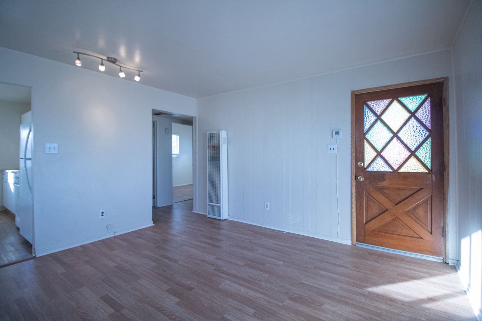 1621 Sims Street Ridgecrest, CA 93555 - Photo 4 of 24 a view of an empty room with wooden floor and a window