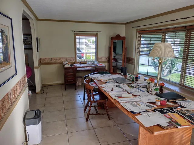 a view of a dining room with furniture and window