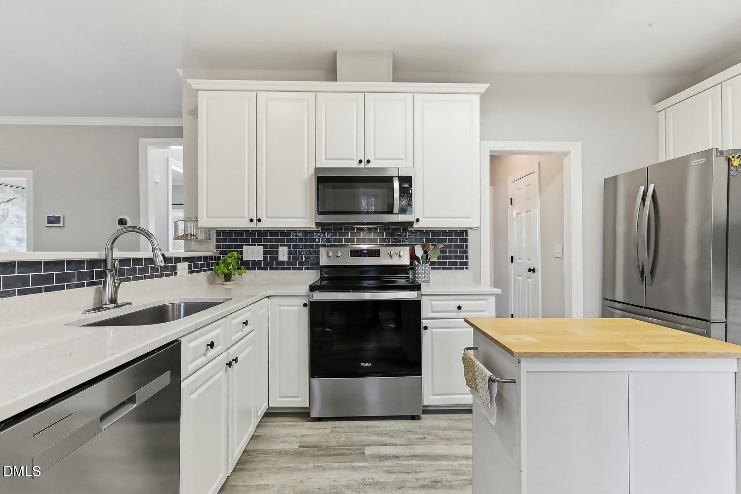 4001 Batiste Road Raleigh, NC 27613 - Photo 17 of 63 a kitchen with a sink stove and refrigerator