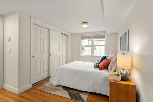 a bedroom with a bed and window