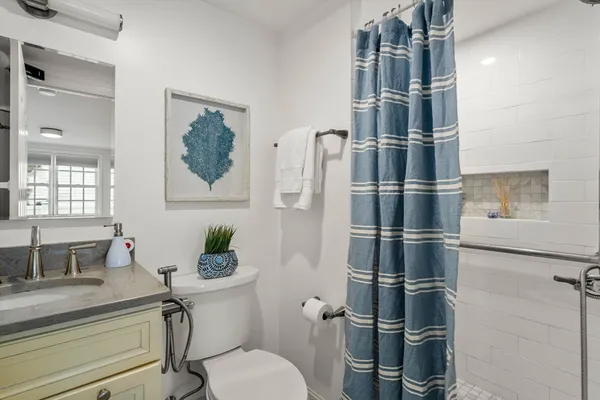 a bathroom with a sink toilet and shower