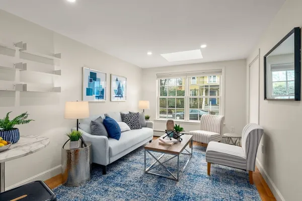 a living room with furniture and a potted plant