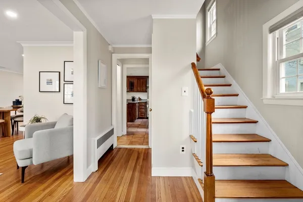 a view of a bedroom with wooden floor and stairs