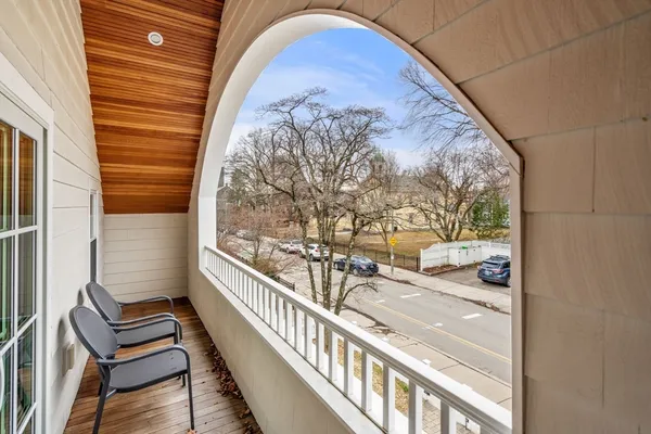 a view of a balcony with wooden floor