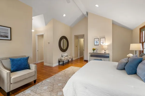 a bedroom with furniture and a mirror