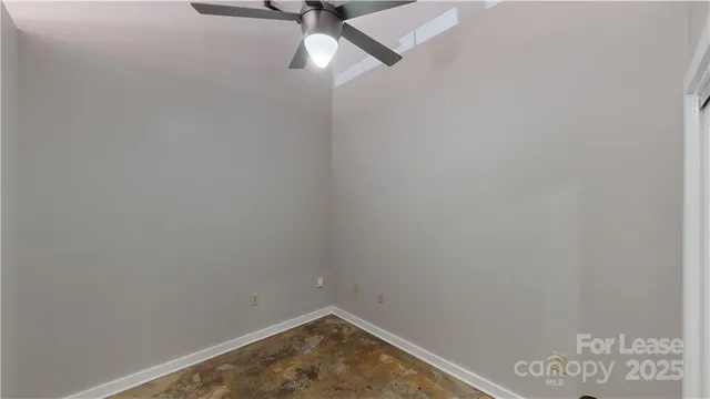 a small space with a fan and a window