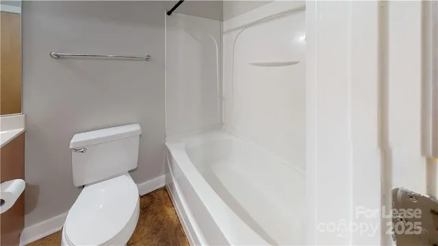 a white toilet sitting next to a bathroom sink