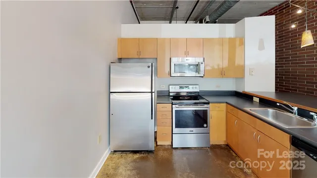 a kitchen with a sink appliances and cabinets