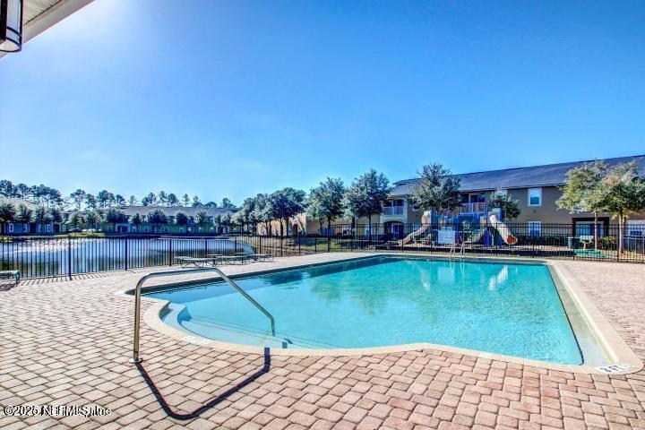 3620 Kirkpatrick Circle, Unit 16 Jacksonville, FL 32210 - Photo 16 of 17 a view of swimming pool with outdoor seating and lake view