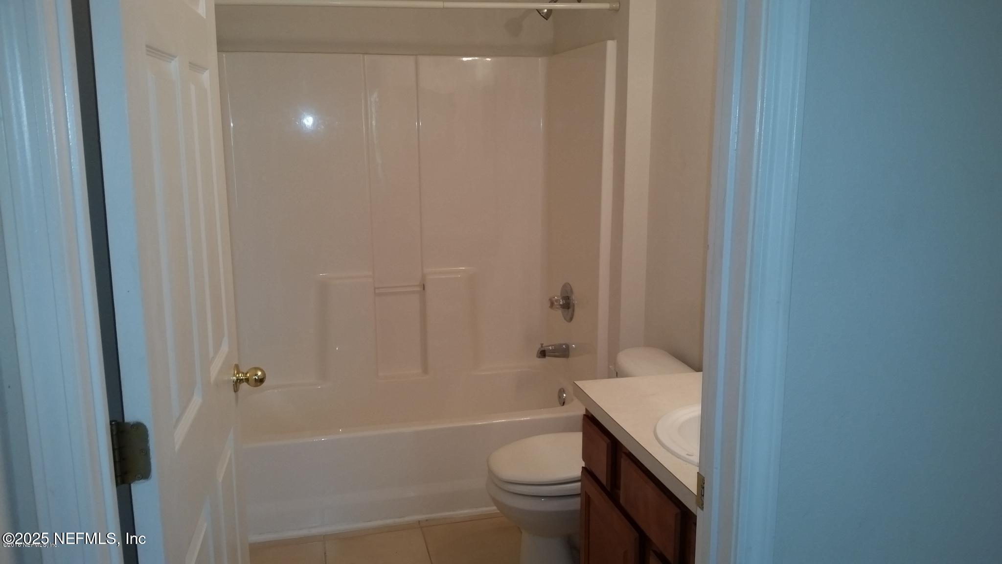 3620 Kirkpatrick Circle, Unit 16 Jacksonville, FL 32210 - Photo 9 of 17 a bathroom with a sink a toilet and shower