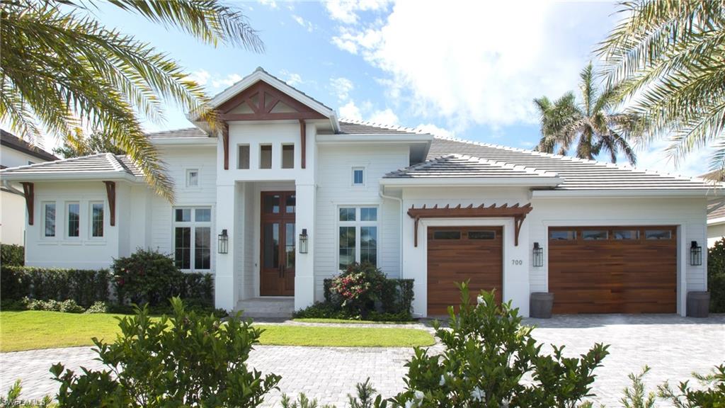 700 Wedge Drive Naples, FL 34103 - Photo 4 of 19 a front view of a house with garden