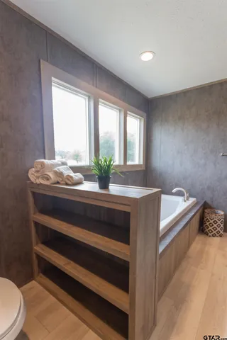 a bathroom with a tub and shower