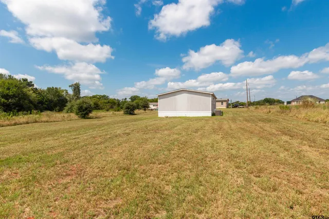 a view of a livingroom with furniture and a kitchen