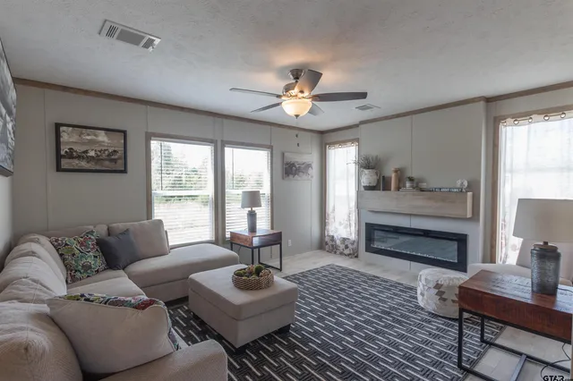 a living room with furniture and a lamp