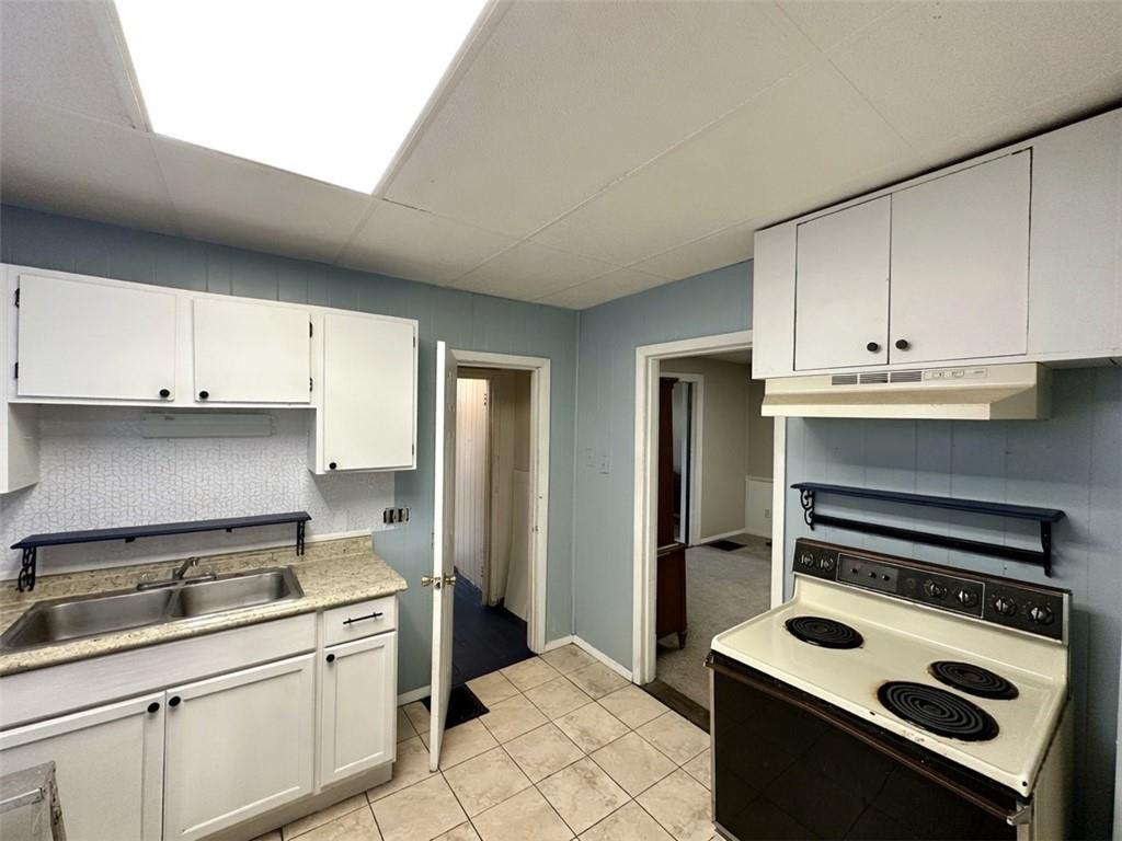 114 South Street Butler, PA 16001 - Photo 16 of 32 a kitchen with a sink stove and cabinets