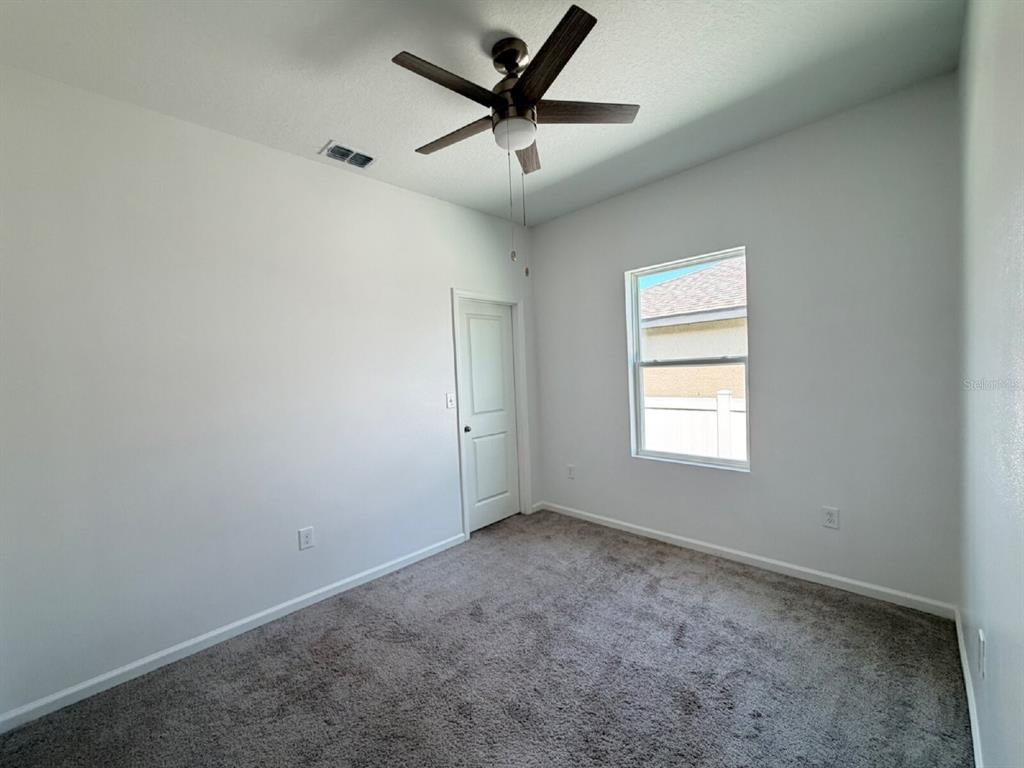 2021 Hemingway Circle Groveland, FL 34736 - Photo 11 of 18 an empty room with a window and a fan