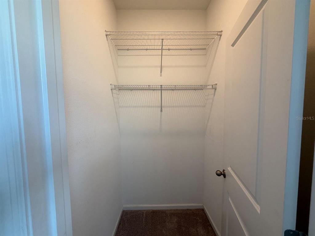2021 Hemingway Circle Groveland, FL 34736 - Photo 12 of 18 a view of a room with racks on the wall