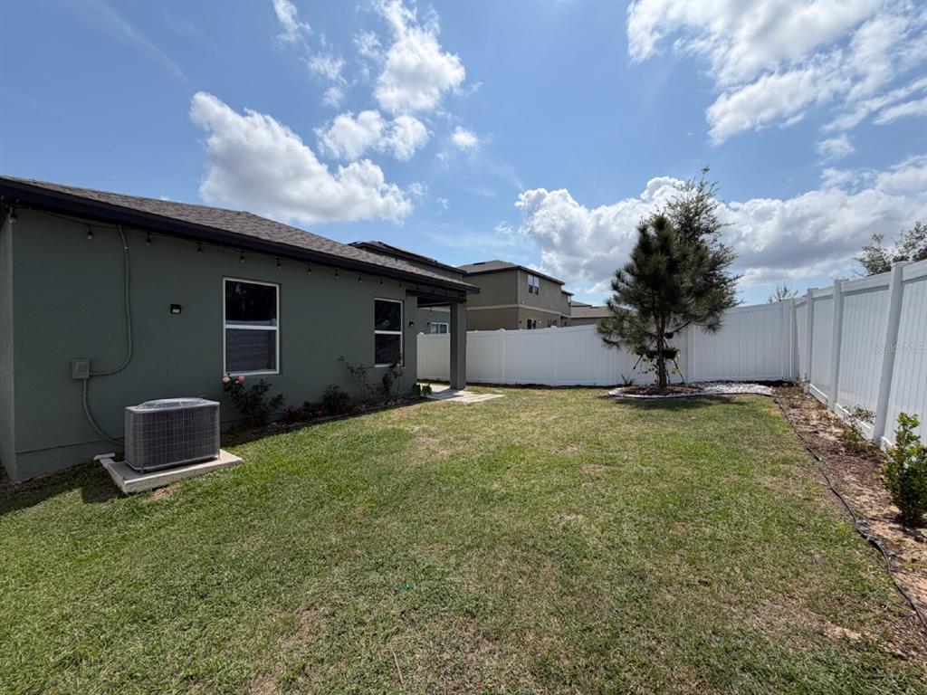 2021 Hemingway Circle Groveland, FL 34736 - Photo 17 of 18 a view of a house with backyard and garden
