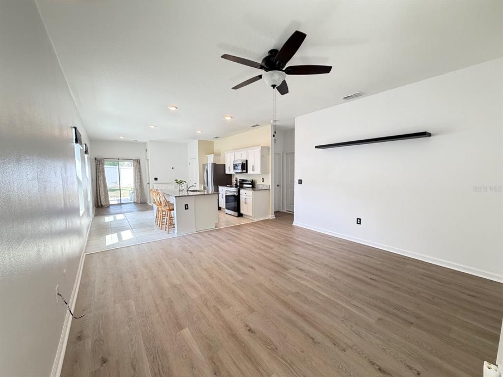 2021 Hemingway Circle Groveland, FL 34736 - Photo 2 of 18 a view of a living room a refrigerator and windows