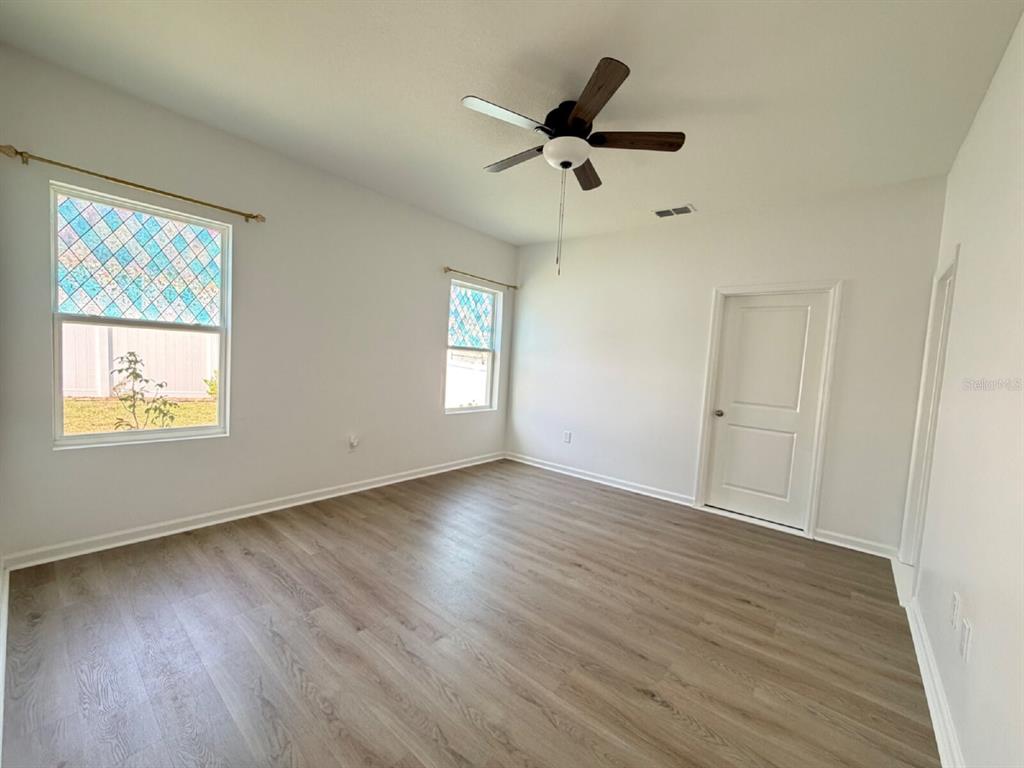2021 Hemingway Circle Groveland, FL 34736 - Photo 5 of 18 a view of empty room with wooden floor and fan