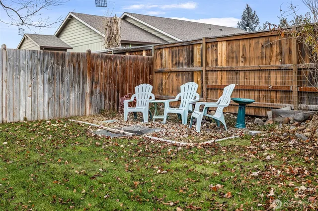 a backyard of a house with table and chairs