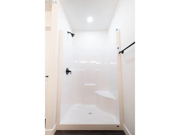 a bathroom with a glass shower door