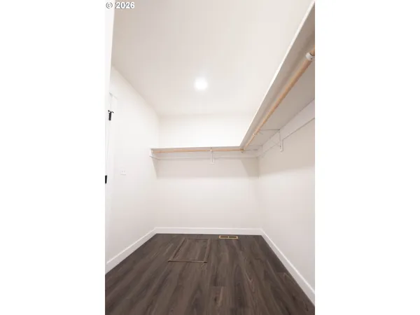 a view of a room with wooden floor