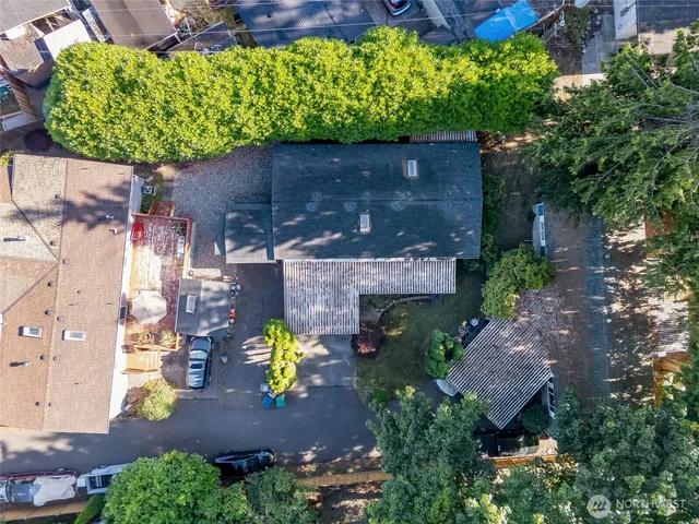 an aerial view of a house with a yard