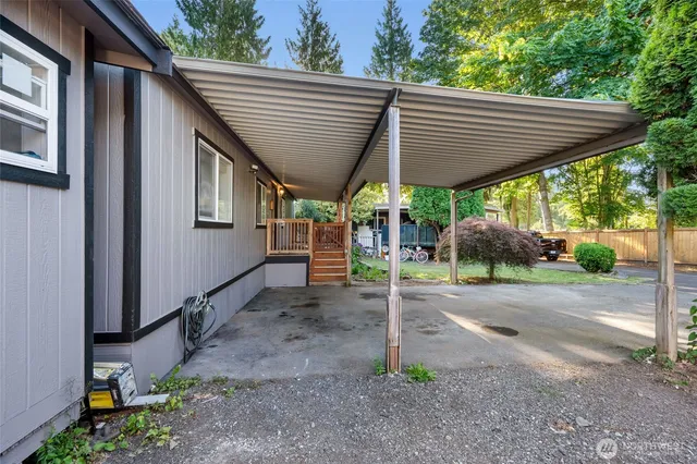 a backyard of a house with table and chairs