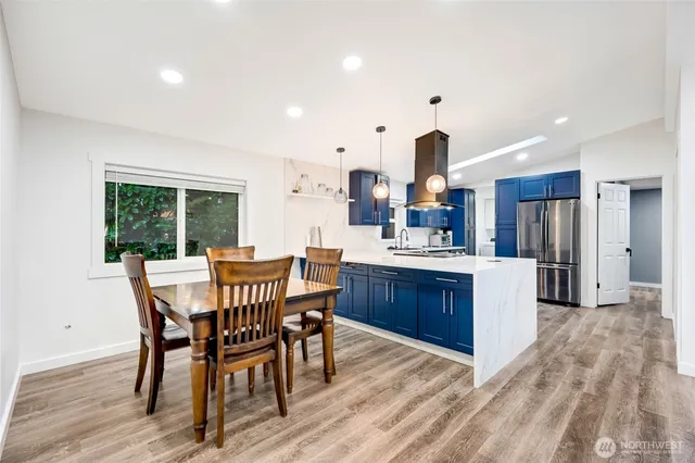 a view of a dining room with furniture window and wooden floor