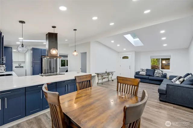 a large kitchen with a table and chairs