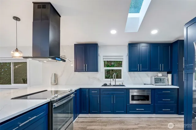 a kitchen with granite countertop wooden cabinets and white appliances